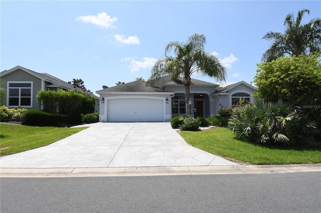2120 Willow Grove Way, The Villages, FL 32162 - ranch-style house featuring driveway, a garage, stucco siding, and a front yard