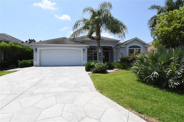 2120 Willow Grove Way, The Villages, FL 32162 - single story home featuring stucco siding, driveway, an attached garage, and a front lawn