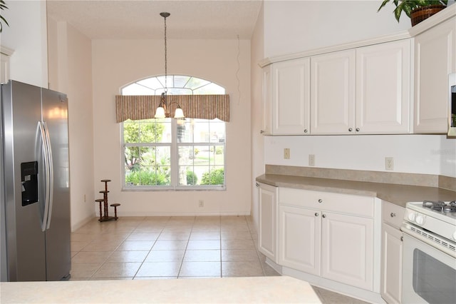 2120 Willow Grove Way, The Villages, FL 32162 - kitchen featuring stainless steel refrigerator with ice dispenser, a chandelier, white gas range, white cabinets, and light tile patterned flooring