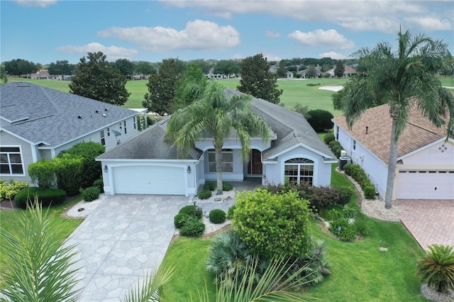 2120 Willow Grove Way, The Villages, FL 32162 - view of front of property featuring driveway, an attached garage, stucco siding, a front lawn, and a shingled roof