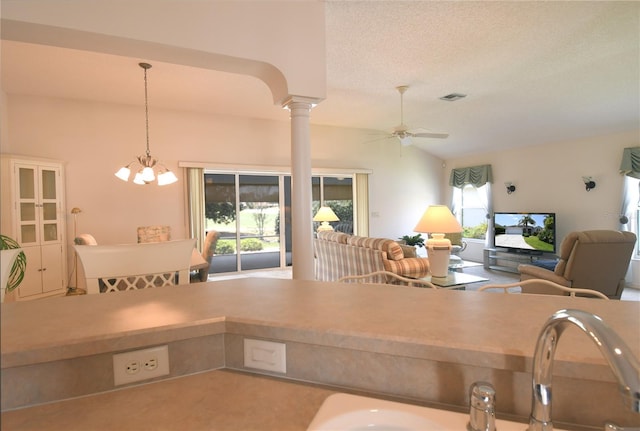 2120 Willow Grove Way, The Villages, FL 32162 - kitchen featuring ceiling fan, open floor plan, decorative columns, a chandelier, and lofted ceiling