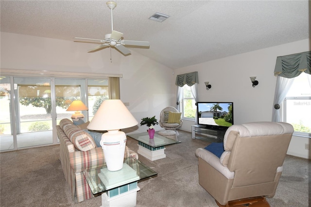 2120 Willow Grove Way, The Villages, FL 32162 - carpeted living room with a ceiling fan, vaulted ceiling, and a textured ceiling