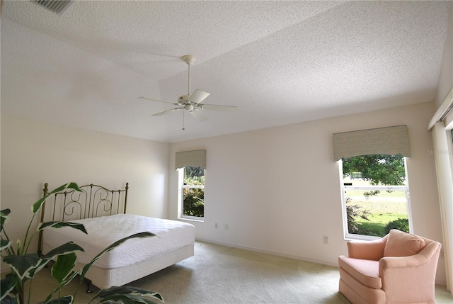2120 Willow Grove Way, The Villages, FL 32162 - bedroom with light carpet, ceiling fan, a textured ceiling, and baseboards