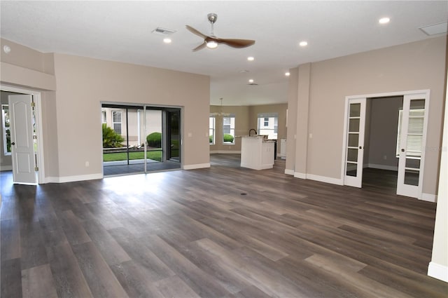 3177 Williams Rd, The Villages, FL 32162 - unfurnished living room with french doors, ceiling fan, recessed lighting, and dark wood finished floors