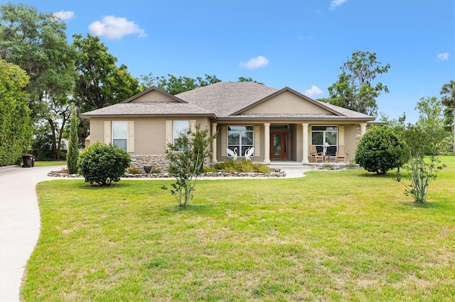 10465 SE 41st Ter, Belleview, FL 34420 - single story home with stucco siding, covered porch, a front yard, and stone siding