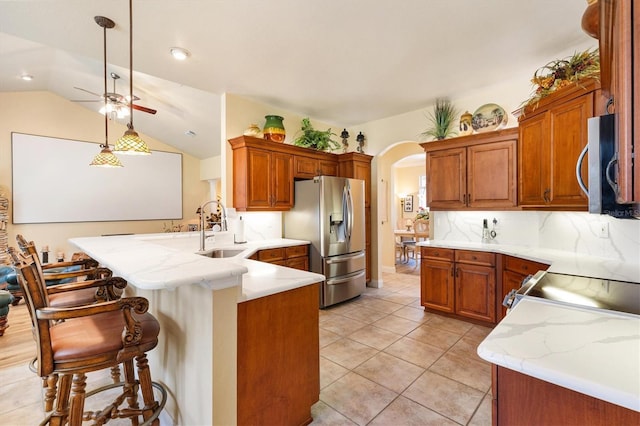 10465 SE 41st Ter, Belleview, FL 34420 - kitchen with stainless steel appliances, a sink, arched walkways, a peninsula, and a ceiling fan