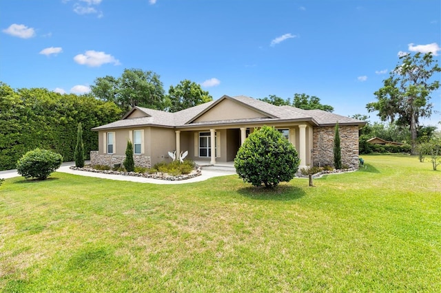 10465 SE 41st Ter, Belleview, FL 34420 - ranch-style house featuring stone siding, stucco siding, a front yard, covered porch, and a shingled roof