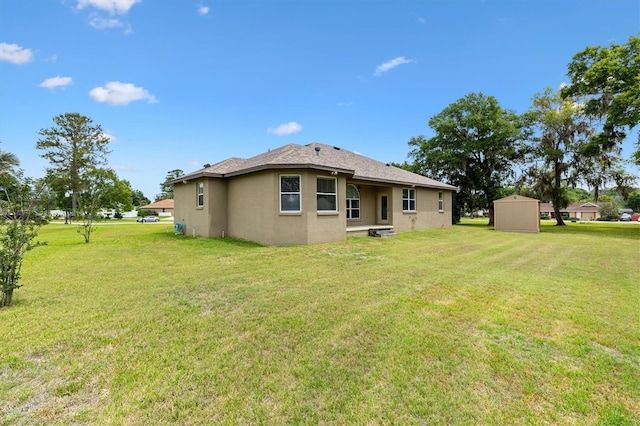 10465 SE 41st Ter, Belleview, FL 34420 - rear view of property with stucco siding, a yard, a storage unit, and an outdoor structure