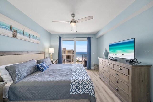 bedroom with access to exterior, light wood-style floors, and a ceiling fan