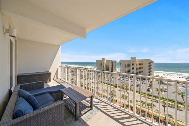 balcony with view of water and beach