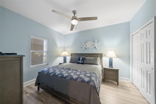 bedroom featuring wood finished floors, baseboards, a closet, and a ceiling fan