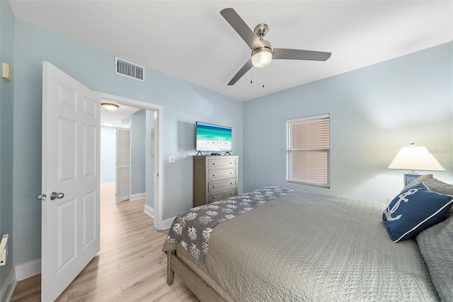 bedroom with wood finished floors, baseboards, and a ceiling fan