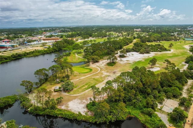 aerial view of property and surrounding area featuring a large body of water, a tree filled landscape, and a local golf course