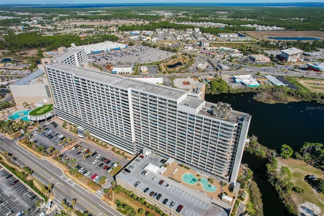 aerial view of property's location with a nearby body of water and a pool