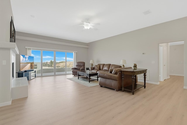 12512 Lake Ridge Cir, Clermont, FL 34711 - living area with a ceiling fan and light wood-style flooring