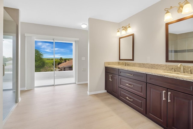 12512 Lake Ridge Cir, Clermont, FL 34711 - full bathroom with double vanity and wood finished floors