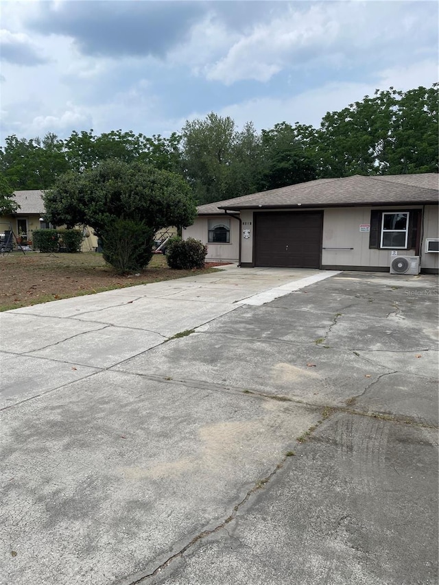 2421 Centennial Blvd, Leesburg, FL 34748 - view of side of home featuring a garage and concrete driveway