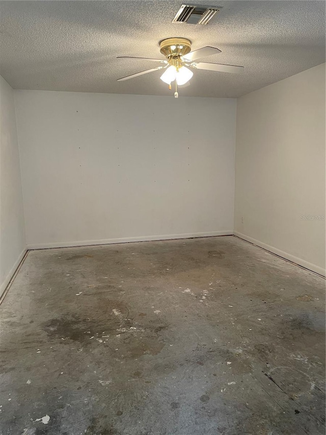 2421 Centennial Blvd, Leesburg, FL 34748 - spare room featuring concrete floors, a ceiling fan, a textured ceiling, and baseboards