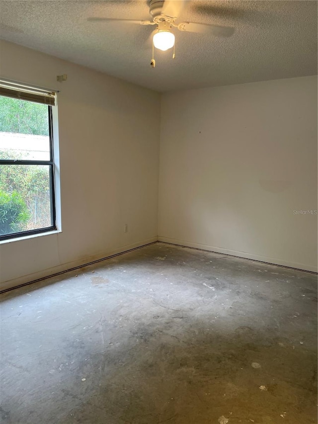 2421 Centennial Blvd, Leesburg, FL 34748 - spare room with concrete floors, a ceiling fan, and a textured ceiling