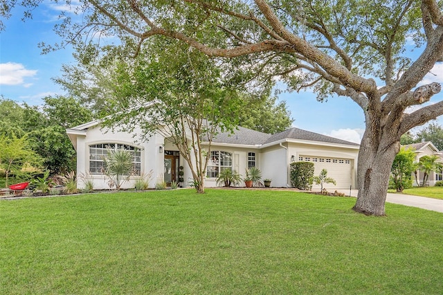 view of front of property featuring stucco siding, an attached garage, concrete driveway, and a front lawn
