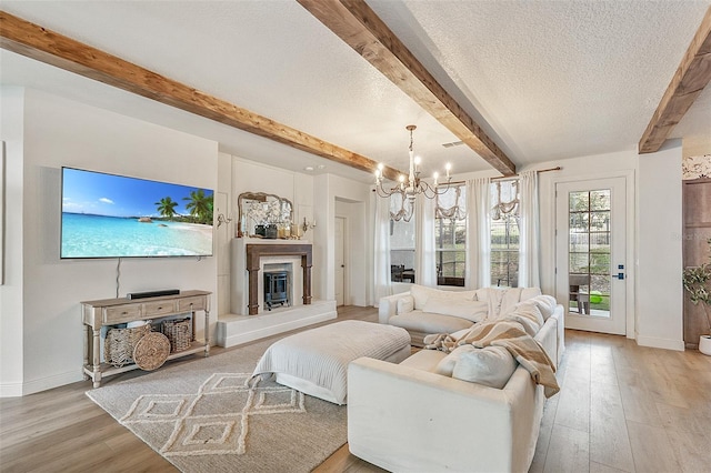 13332 Via Roma Cir, Clermont, FL 34711 - bedroom with beam ceiling, baseboards, light wood finished floors, a chandelier, and a textured ceiling