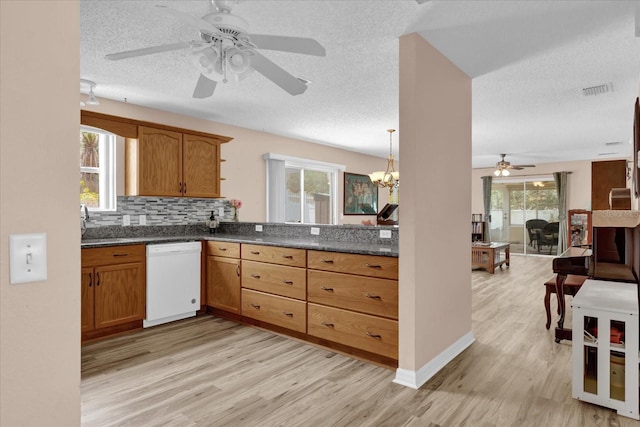 8932 SE 168th Sedgwick Pl, The Villages, FL 32162 - kitchen featuring dishwasher, ceiling fan, light wood-style floors, dark countertops, and a textured ceiling