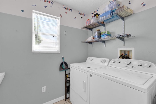 8932 SE 168th Sedgwick Pl, The Villages, FL 32162 - laundry room featuring washer and clothes dryer, baseboards, and light tile patterned floors