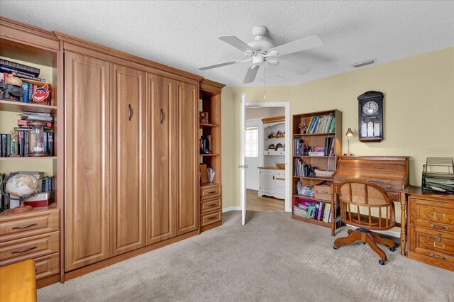8932 SE 168th Sedgwick Pl, The Villages, FL 32162 - office area with a ceiling fan, light carpet, and a textured ceiling