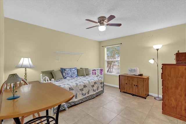 8932 SE 168th Sedgwick Pl, The Villages, FL 32162 - bedroom with light tile patterned floors, baseboards, a textured ceiling, and a ceiling fan