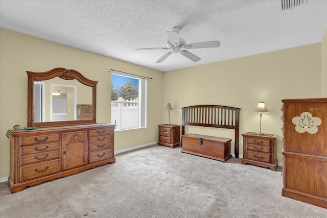8932 SE 168th Sedgwick Pl, The Villages, FL 32162 - carpeted bedroom featuring a textured ceiling, a ceiling fan, and baseboards