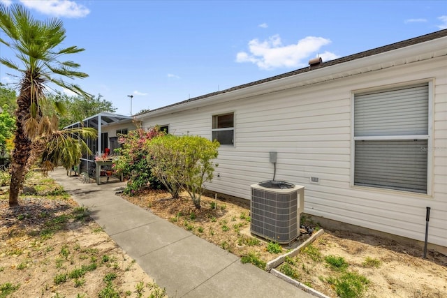 8932 SE 168th Sedgwick Pl, The Villages, FL 32162 - view of side of property with central AC and glass enclosure