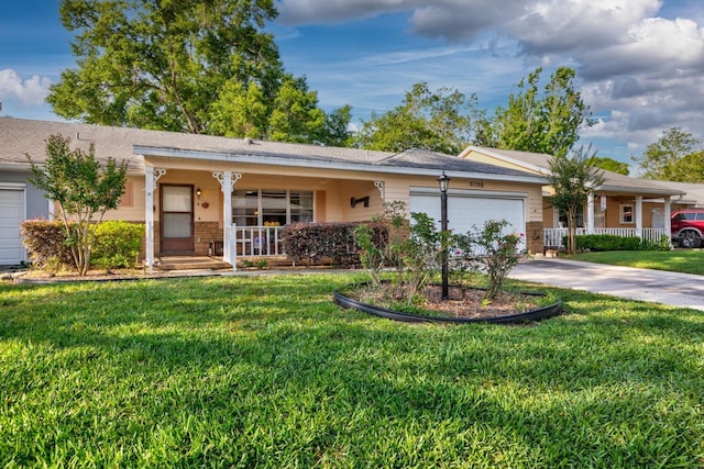 single story home featuring a porch, a garage, a front yard, driveway, and brick siding