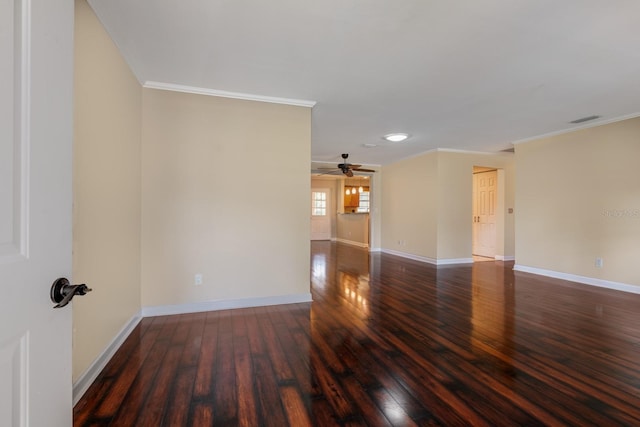 spare room with crown molding, hardwood / wood-style flooring, baseboards, and ceiling fan