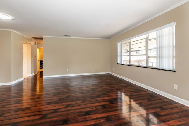 unfurnished room featuring dark wood finished floors, crown molding, and baseboards