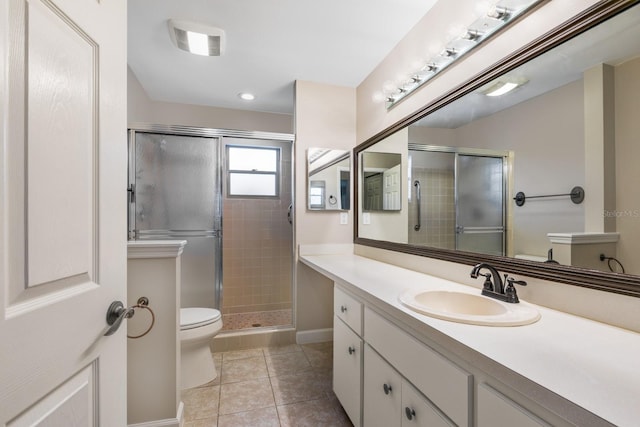 full bathroom with a shower stall, tile patterned floors, toilet, vanity, and baseboards