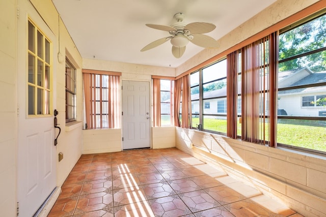 unfurnished sunroom with healthy amount of natural light and tile patterned floors