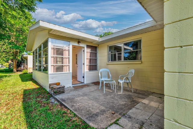 back of house with a sunroom and a patio area