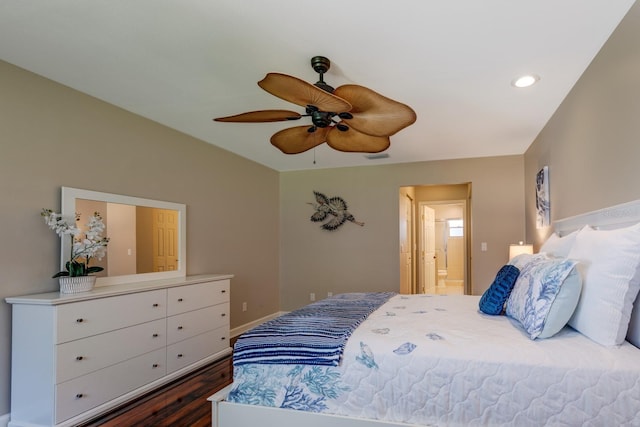 8738 SW 95th Ln Unit B, Ocala, FL 34481 - bedroom with dark wood finished floors, a ceiling fan, and connected bathroom
