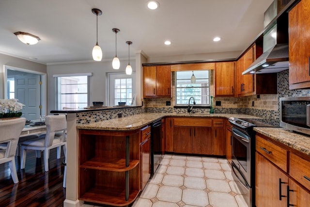 8738 SW 95th Ln Unit B, Ocala, FL 34481 - kitchen featuring stainless steel appliances, wall chimney range hood, open shelves, brown cabinets, and crown molding