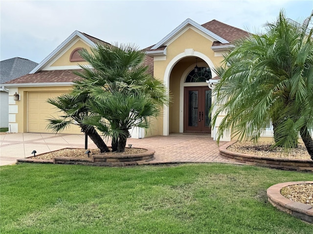 2918 Canyon Ave, The Villages, FL 32163 - view of front facade featuring french doors, stucco siding, concrete driveway, and a front yard