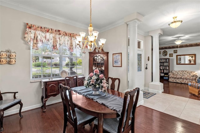 dining room with ornate columns, hardwood / wood-style flooring, ornamental molding, a ceiling fan, and baseboards