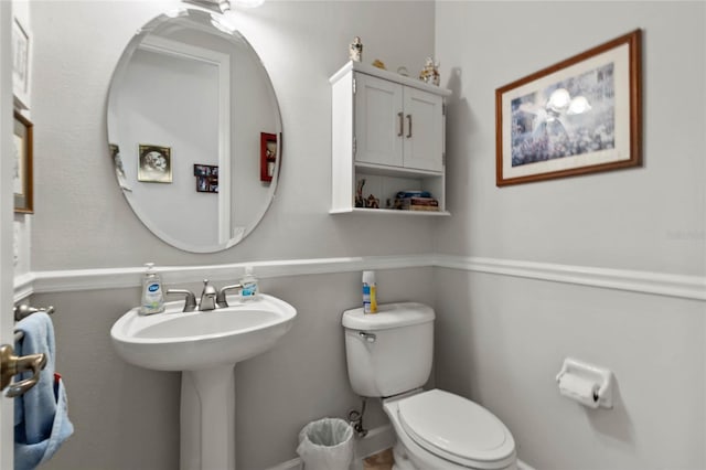 half bath with toilet and a sink