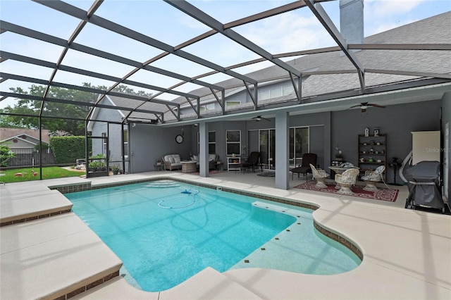 view of pool featuring ceiling fan, a patio, an outdoor hangout area, and glass enclosure