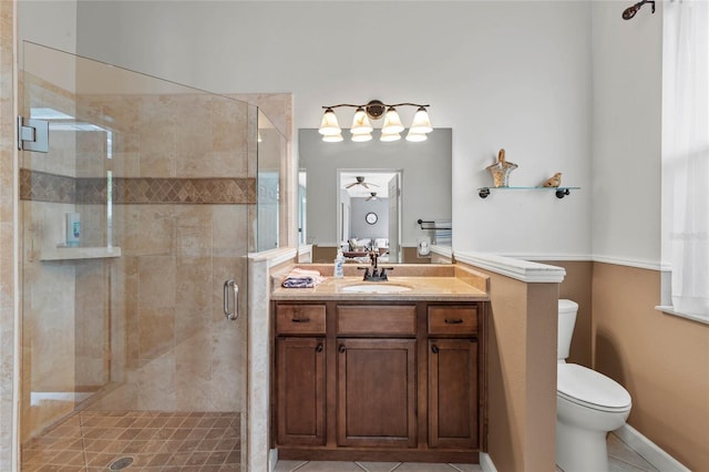 bathroom with toilet, a stall shower, vanity, and tile patterned flooring