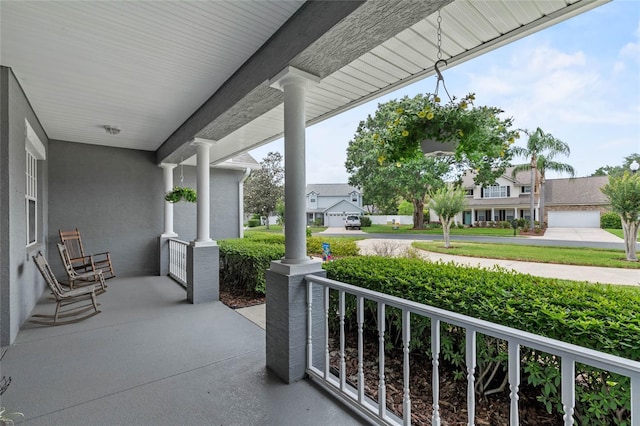 view of patio / terrace featuring a porch and a residential view