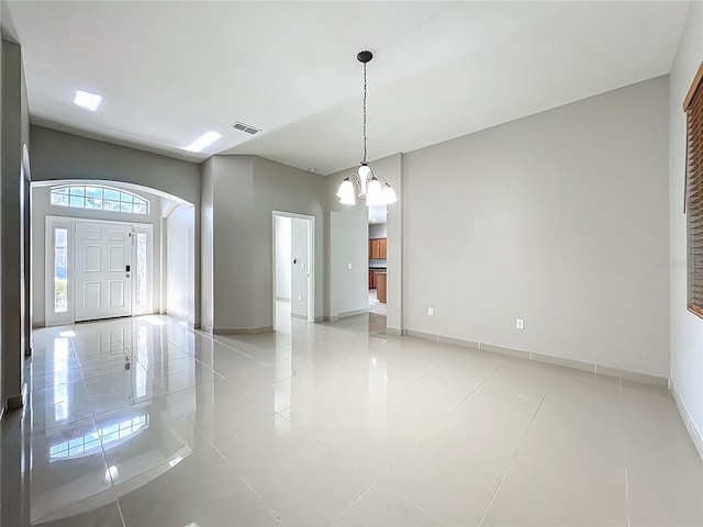 3731 Peaceful Valley Dr, Clermont, FL 34711 - foyer entrance featuring arched walkways, a chandelier, and light tile patterned floors