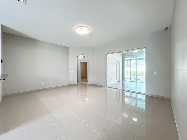 3731 Peaceful Valley Dr, Clermont, FL 34711 - empty room featuring light tile patterned floors and arched walkways