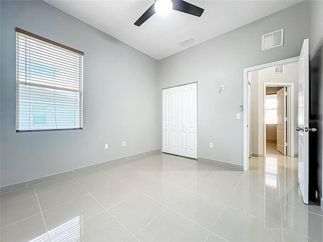3731 Peaceful Valley Dr, Clermont, FL 34711 - unfurnished bedroom featuring light tile patterned flooring, a closet, and a ceiling fan