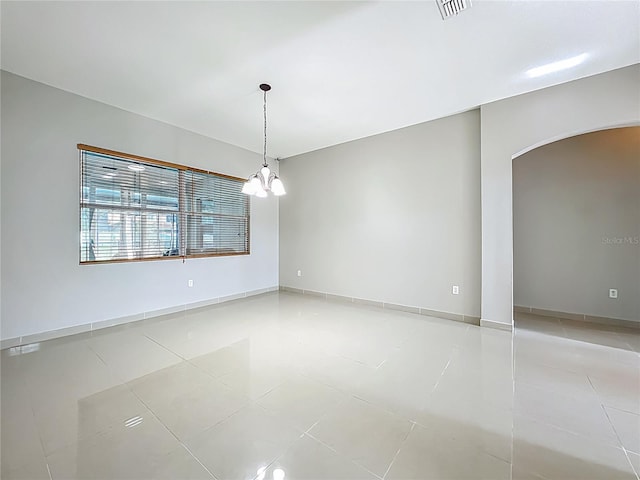 3731 Peaceful Valley Dr, Clermont, FL 34711 - spare room with arched walkways, light tile patterned floors, and a chandelier
