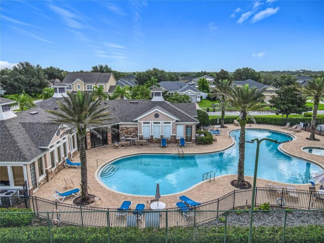 3731 Peaceful Valley Dr, Clermont, FL 34711 - community pool featuring a patio area and a residential view
